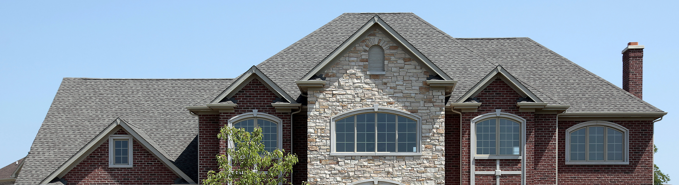 Large home with a gray shingle roof