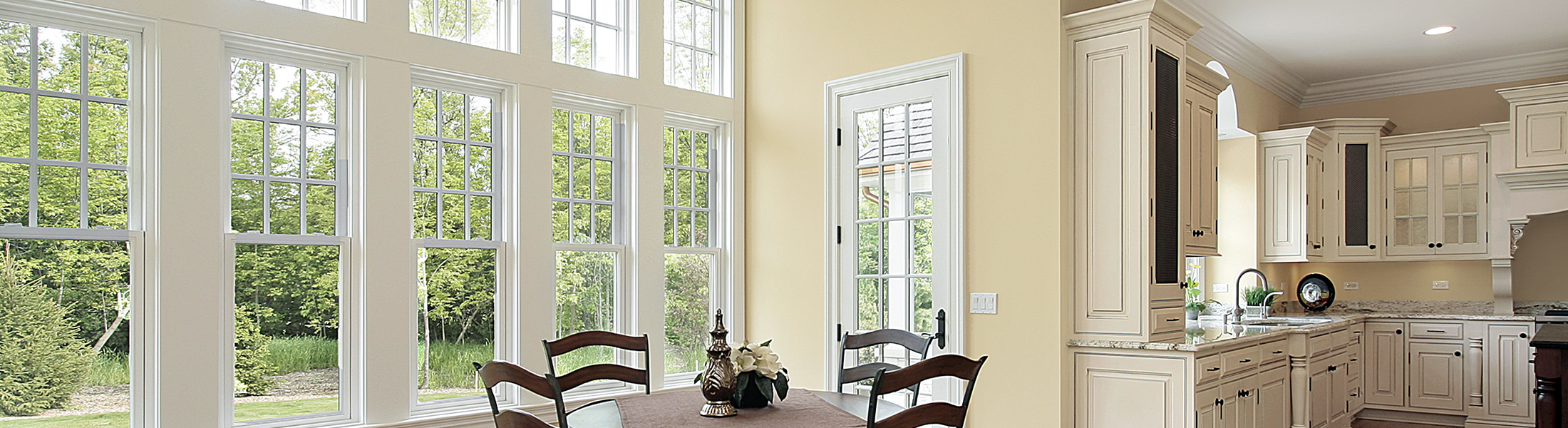 Modern kitchen and dining room area next to windows